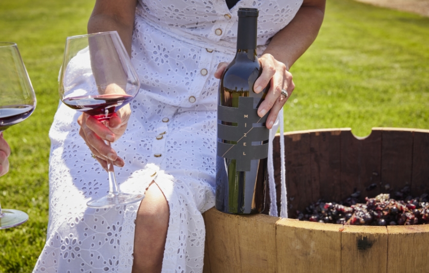 Woman Seated on Wine Barrel with Mizel Wine