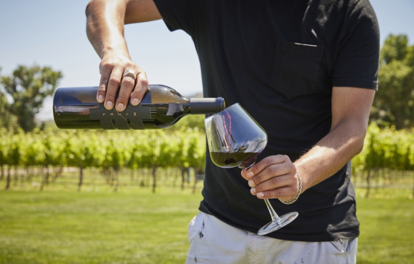 Man Pouring Wine in Mizel Estate Vineyard